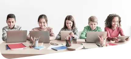 A group of five children sitting right next to each other using their laptops.