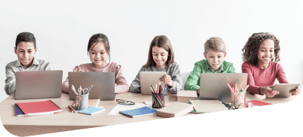 A group of five children sitting right next to each other using their laptops and tablets while in the classroom